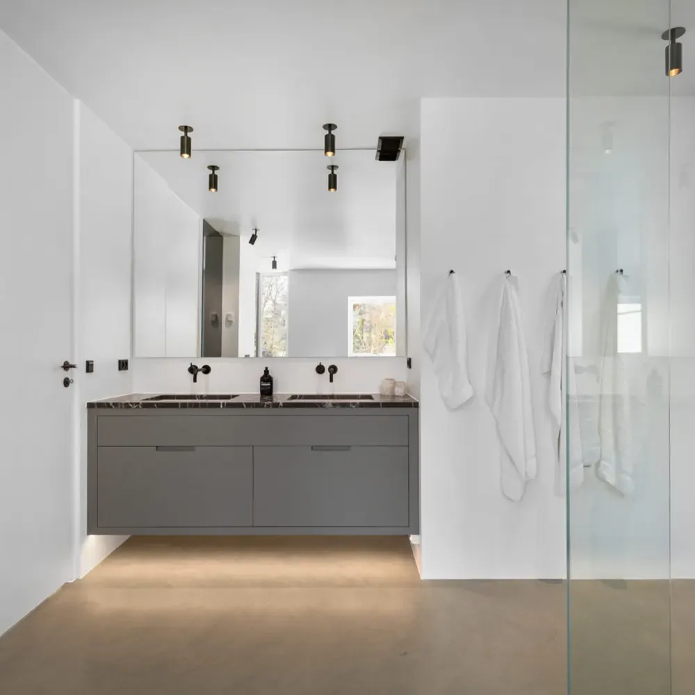 A bathroom with seamless microcement walls and floor