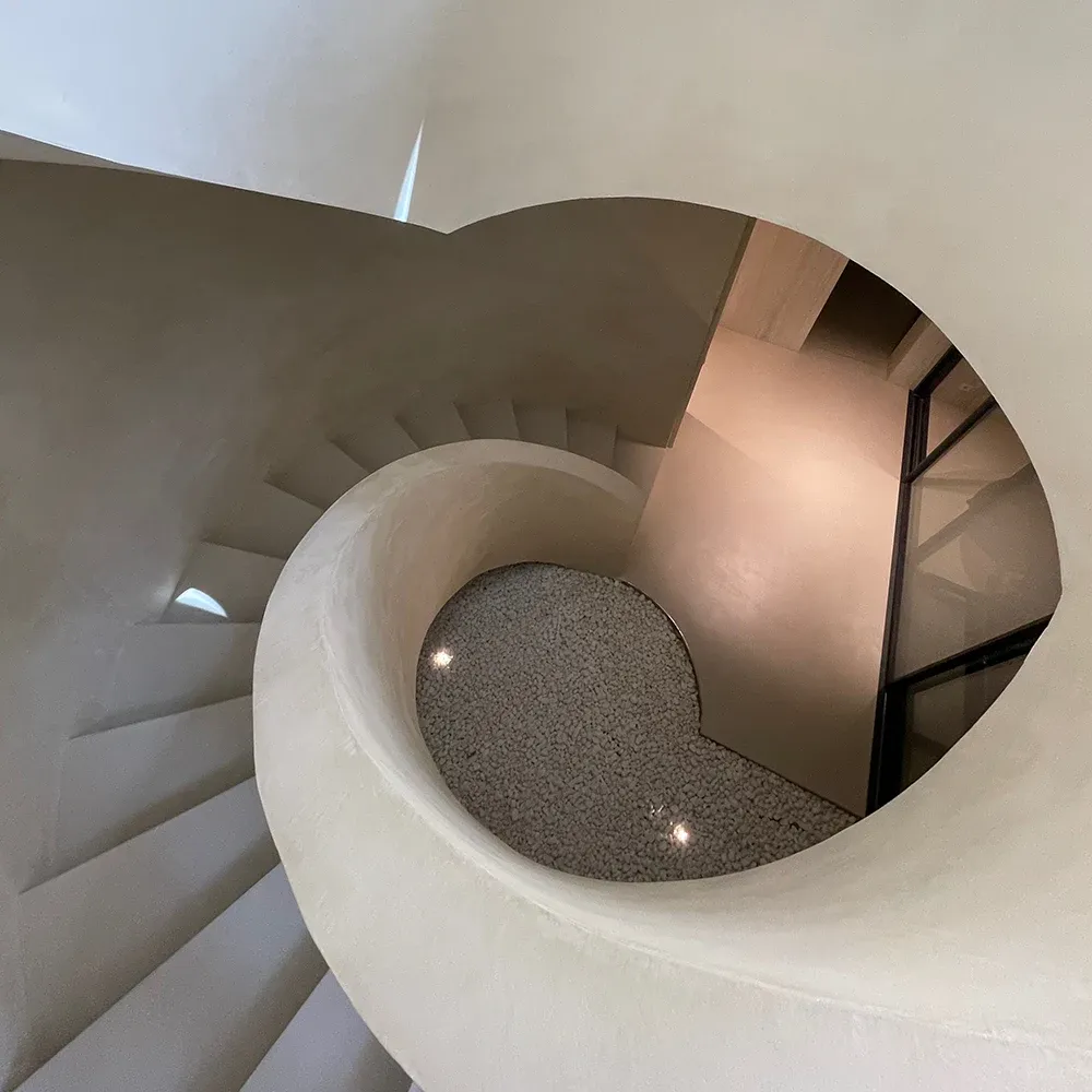 A spiral staircase finished in microcement