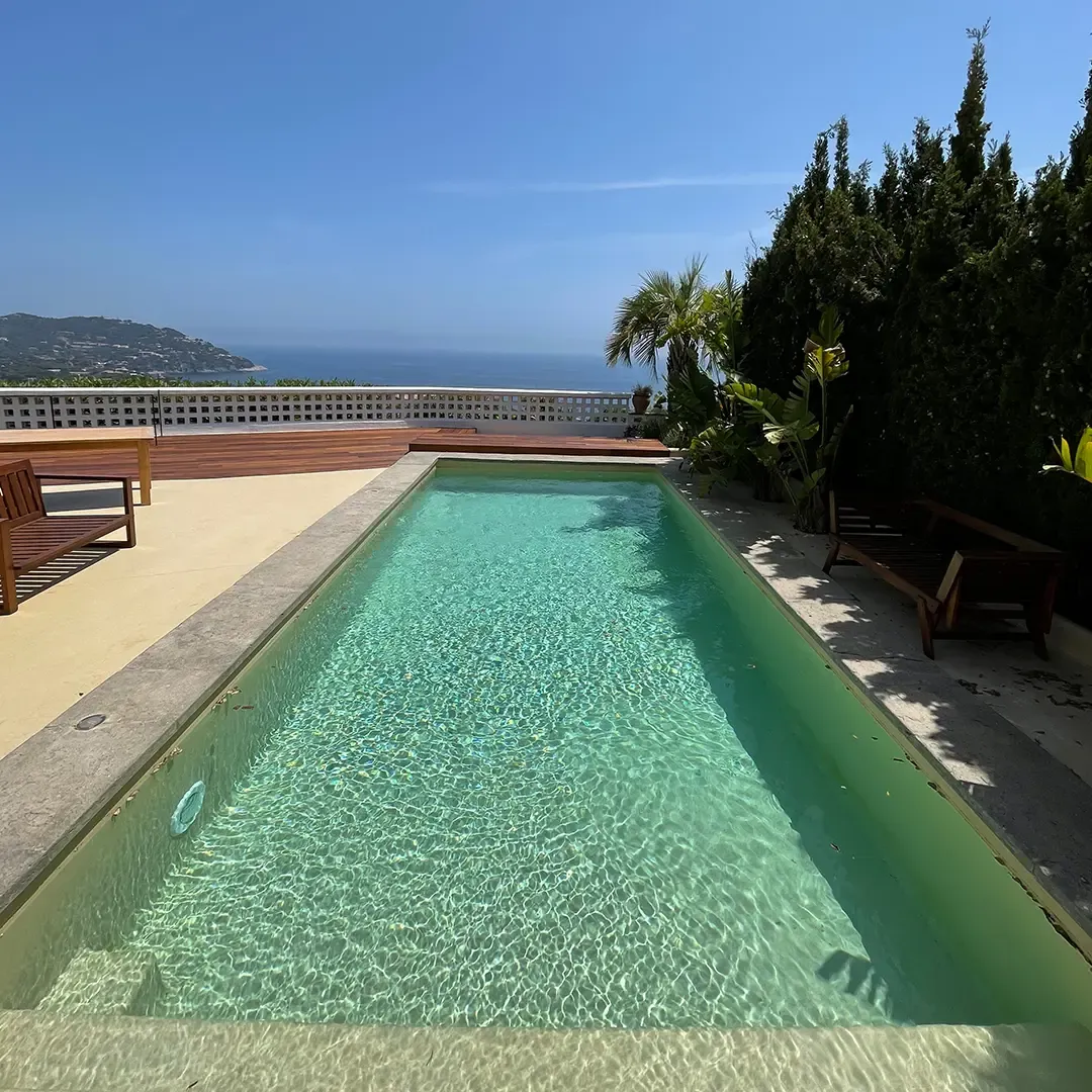 A long pool with sea views, lined with T/Swim®